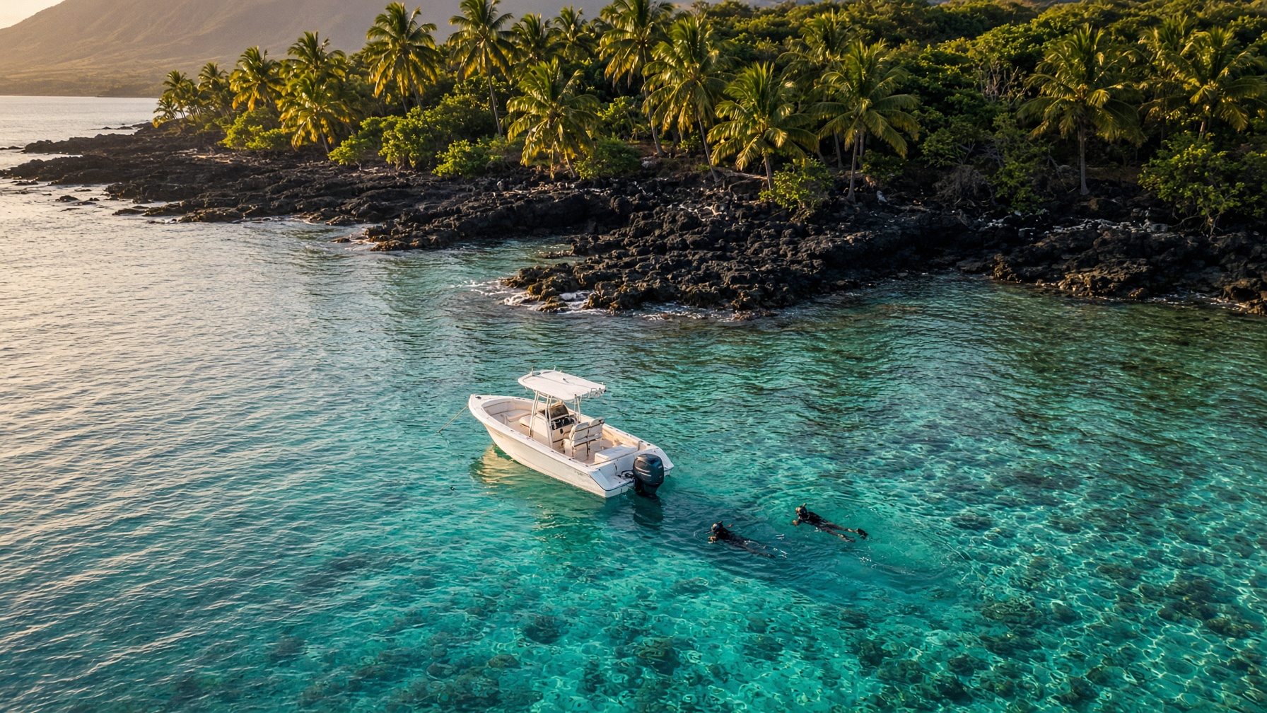 Small tour boat and snorkelers on the Kona coast